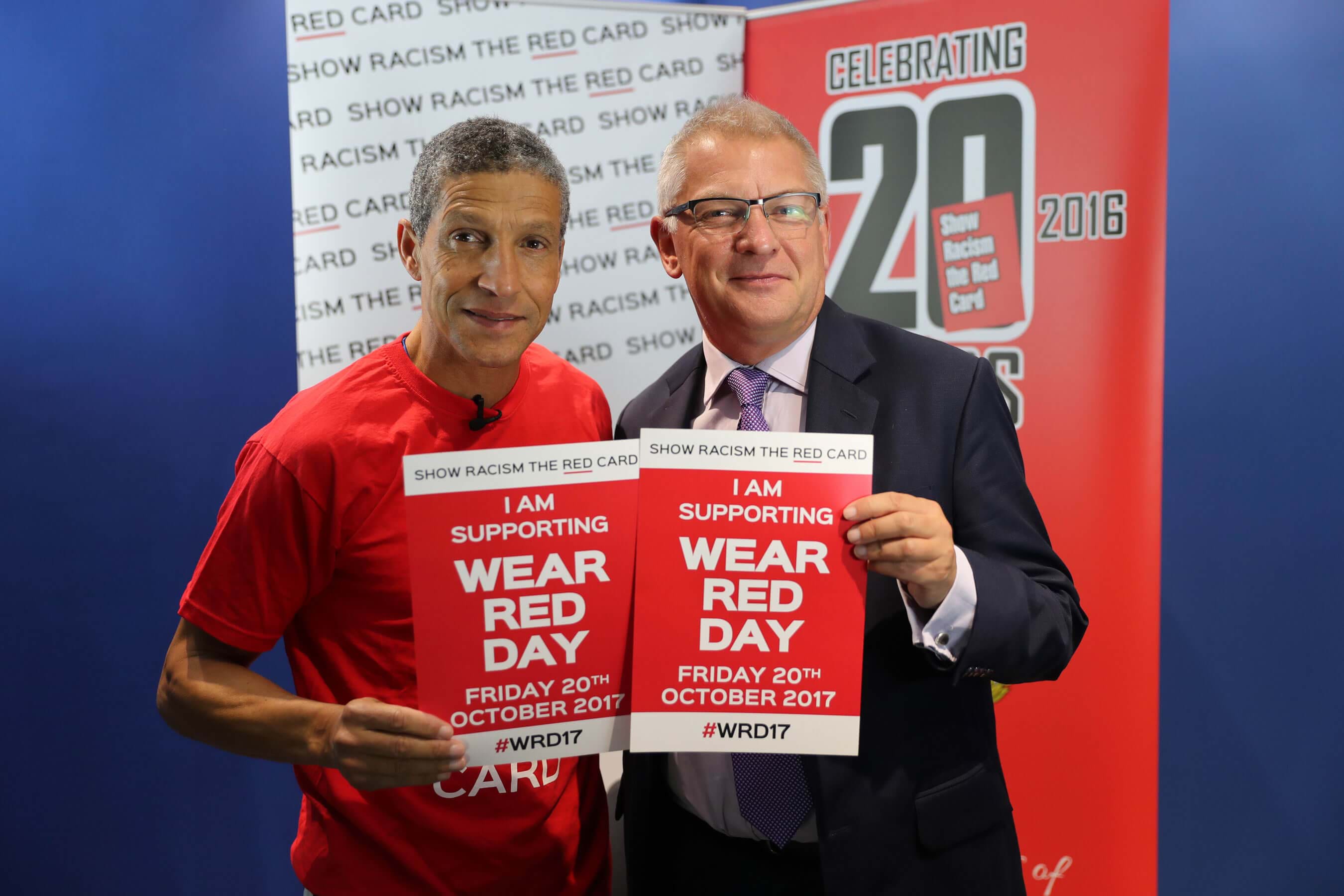 Irish former professional footballer and current manager of Brighton & Hove Albion, Chris Hughton, and Thompsons Solicitors’ chief executive, Stephen Cavalier, hold Show Racism the Red Card posters.